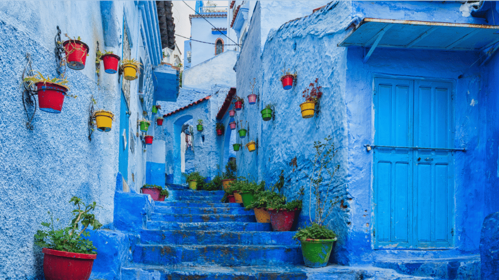 View across Chefchaouen blue and white houses beneath the Rif Mountains